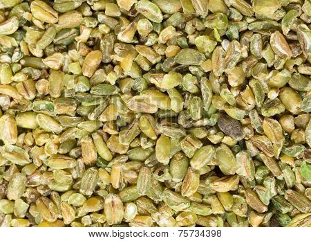 Grains of uncooked freekeh, an old Middle Eastern cereal made by fire-roasting immature wheat grains. The cereal has a very low glycemic index and is high in protein, fibre and minerals