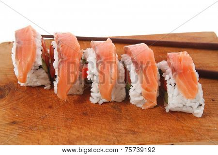 classic onigiri inside out californian sushi rolls with salmon on wooden plate isolated over white background with sticks high resolution hidef