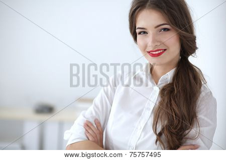 Attractive businesswoman with her arms crossed stnding