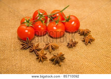 Red Tomats And Star Anise Fruits On Old Cloth
