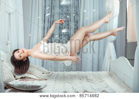 Cute Girl Hovers Over The Bed.