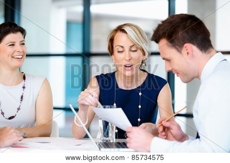 Businesswoman doing a presentaion in front of her collegues