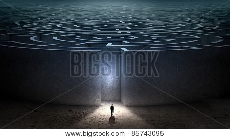 Puzzled businessman standing near entrance of labyrinth
