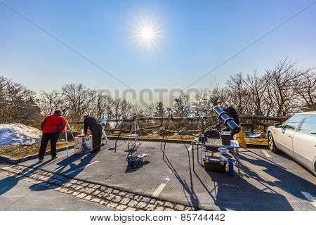 People Watch The Partial Eclipse At The Feldberg