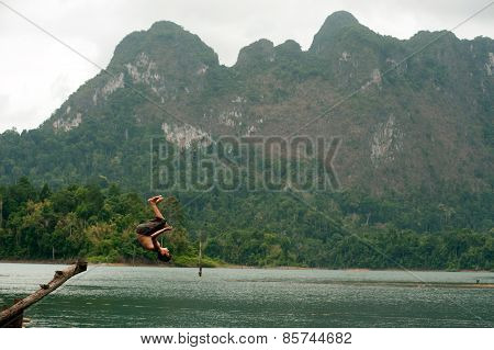 Tourists Fun Jumping Water In Cheow Larn Lake (ratchaprapa Dam),Thailand.