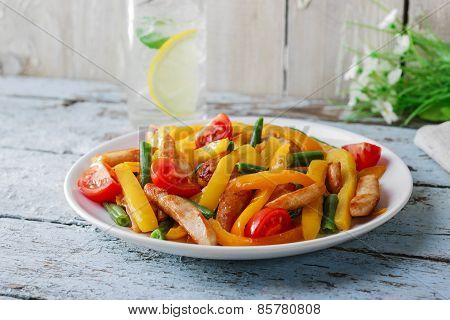 fried sliced chicken fillet bell peppers tomatoes  green beans