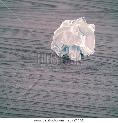 white crumpled paper on wood table background