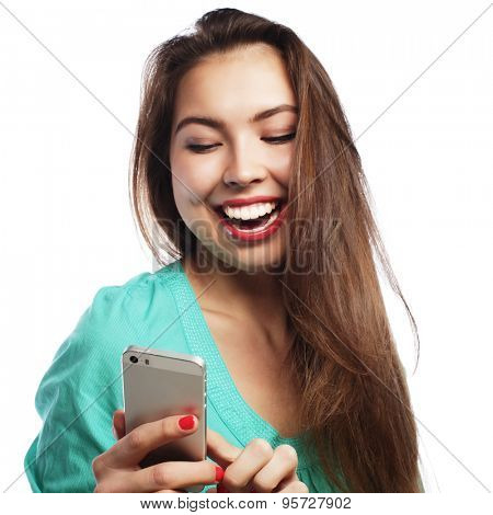 People, lifestyle and tehnology concept: pretty teen girl wearing green shirt, taking selfies with her smart phone -  isolated on white 