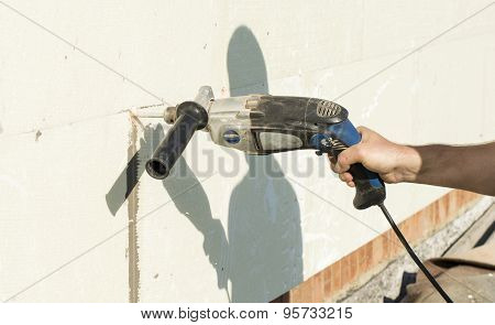 The Process Of Drilling Holes In The White Polyfoam