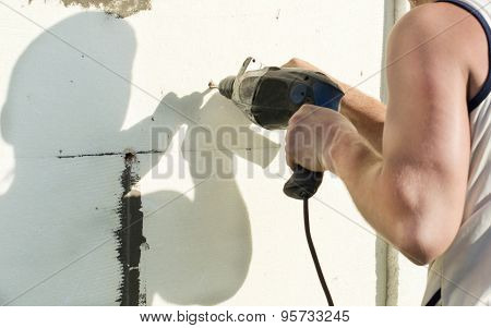 The Process Of Drilling Holes In The White Polyfoam