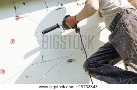 The Process Of Drilling Holes In The White Polyfoam