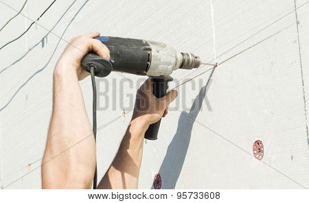 The Process Of Drilling Holes In The White Polyfoam