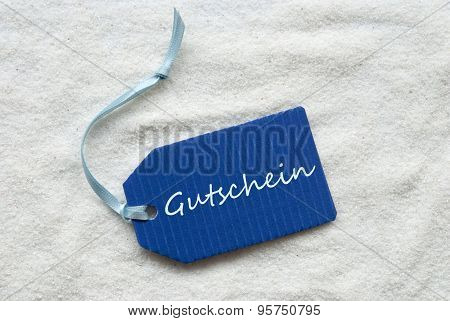 Gutschein Means Voucher On Blue Label Sand