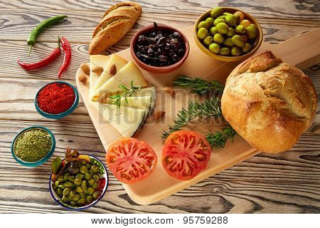 Mediterranean food bread oil olives cheese spices peppers garlic almods rosemary