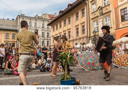 KRAKOW, POLAND - JUL 12, 2015: Participants at the annually (July 9-12) 28th International Festival of Street Theatres - Orchestre International du Vetex (Belgium/France) in the Main Square of Krakow.