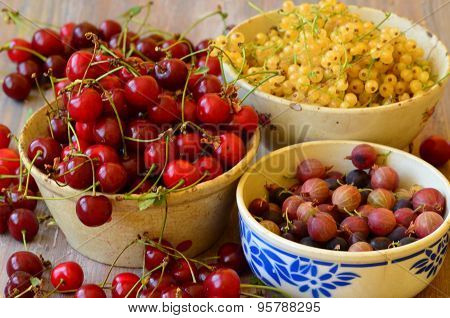 Cherries, currants and gooseberries in vintage bowls