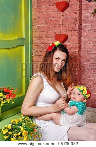 Firstborn Is Sitting On Her Knees Her Mother.