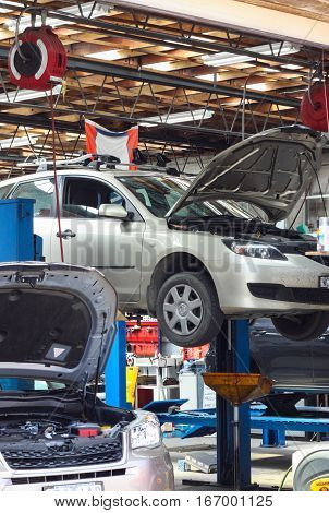Cars waiting for repair at a mechanic auto garage.