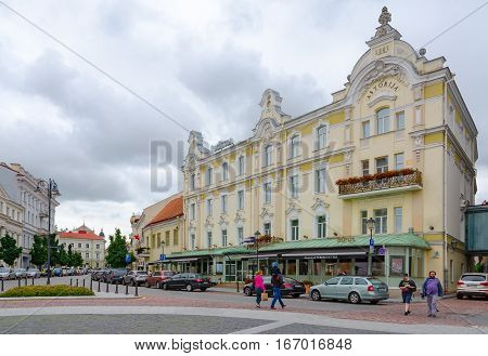 VILNIUS LITHUANIA - JULY 10 2015: Unidentified people are walking on street near Radisson Blu Royal Astorija Hotel 5 * in Old town Vilnius Lithuania