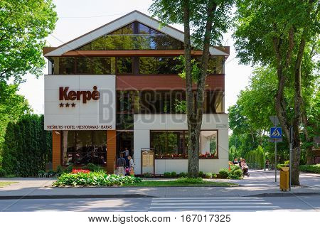 PALANGA LITHUANIA - JULY 12 2015: Unidentified people come into three-star hotel Kerpe in popular resort town of Palanga Lithuania