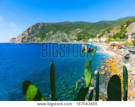 Monterosso Italy - People on the coastline of Monterosso in Italy. Monterosso is one of five famous coastline villages in the Cinque Terre National Park.