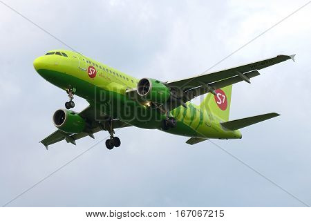 ST. PETERSBURG, RUSSIA - JULY 03, 2016: The Airbus A319-113 plane (VP-BTQ) of S7 Siberia Airlines airline flying in the cloudy sky