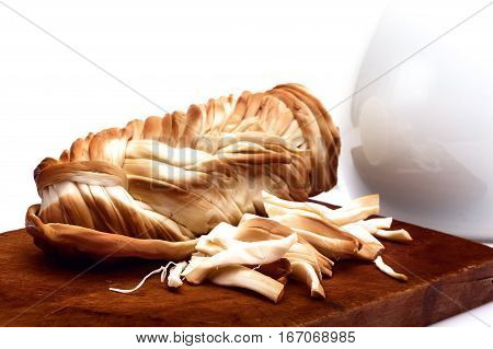 chechil cheese on a cutting board. Isolated