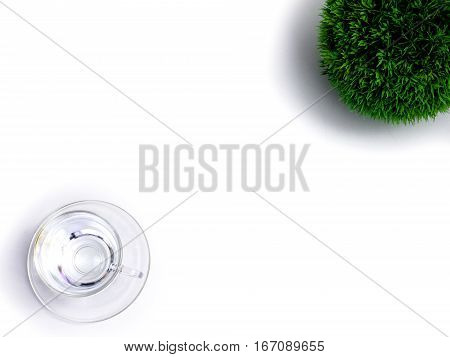 Minimal white office desk table  glass of drinking water and flower pot. Top view with copy space, flat lay.