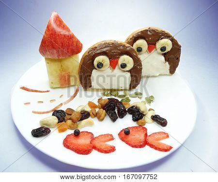 creative breakfast food with fruit and chocolate sweet cream on bread