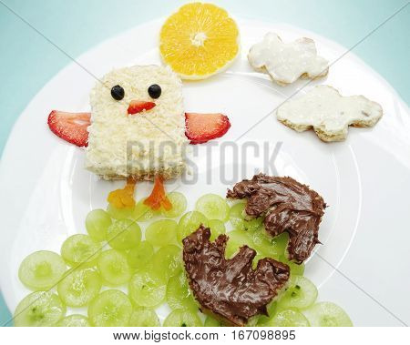 creative breakfast food with fruit and chocolate sweet cream on bread