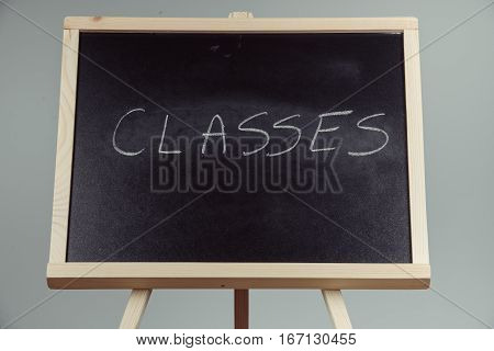 Classes Written In White Chalk On A Black Chalkboard