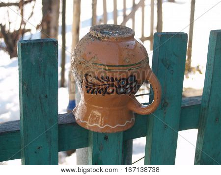 ceramic glechik upside-down weighs on the fence