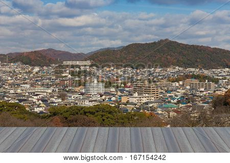 Opening wooden floor Himaji cityscape downtown with mountain background Japan