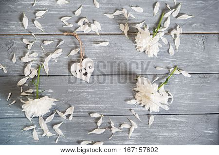 Happy Valentines Day background. Decorative white wooden hearts on grey rustic wooden background. Valentine's Day