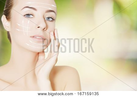 beautiful woman face with surgery marks on green