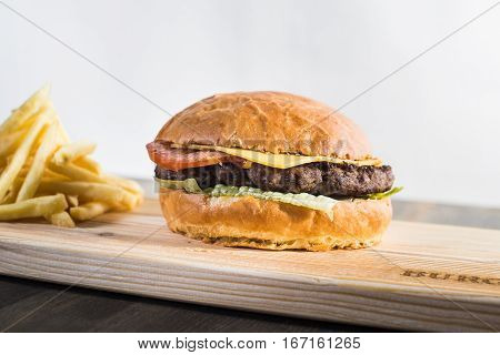 Crafting A Burger On The Board With Fries