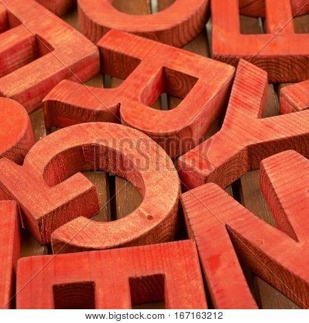 Surface coated with the multiple painted wooden block letters as an abstract backrop composition