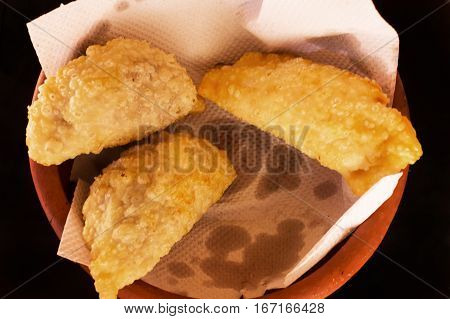 The Argentinian fried empanadas on terracotta dish