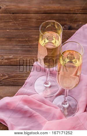 Festive evening with champagne glasses on wooden table