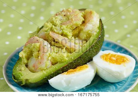 Stuffed avocado with garlic, eggs and shrimps