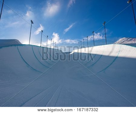 Empty winter snow halfpipe on a sunny day