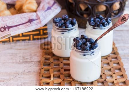 Homemade yogurt with blueberries in a glass jar