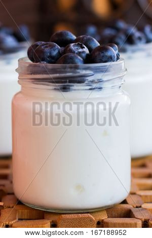 Homemade yogurt with blueberries in a glass jar
