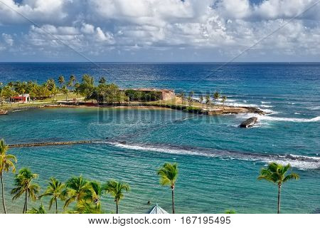 View from the Caribe Hilton into the ocean and small fort