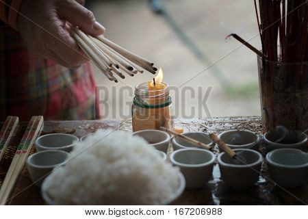 Lighted Candle And Incense For Buddha.