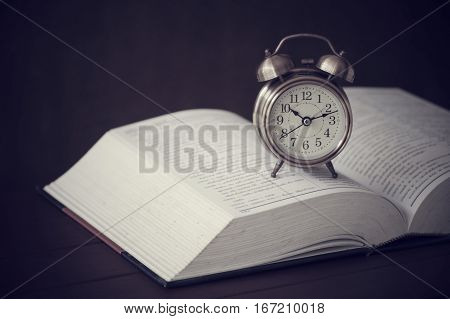 clock alarm books book old retro table time education vintage concept library stack background antique up reading literature floor art watch morning closeup history brown paper wood knowledge wisdom alarm-clock clocks school open