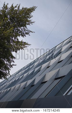 Modern architecture - new buildings, trees, sky and glass