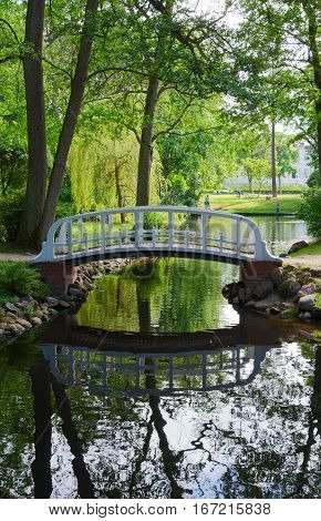 Bridge across pond in Botanical Park beautiful summer view Palanga Lithuania