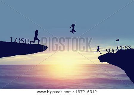 Silhouette of people jumping from lose side on rock to success and celebrat in business fiance and life