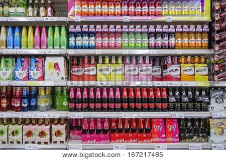 BANGKOK THAILAND - JANUARY 25 2017 : Shelves with bottles low alcohol drinks selling of Spy Breezer in Tesco lotus supermarket. Tesco is the world's second largest retailer